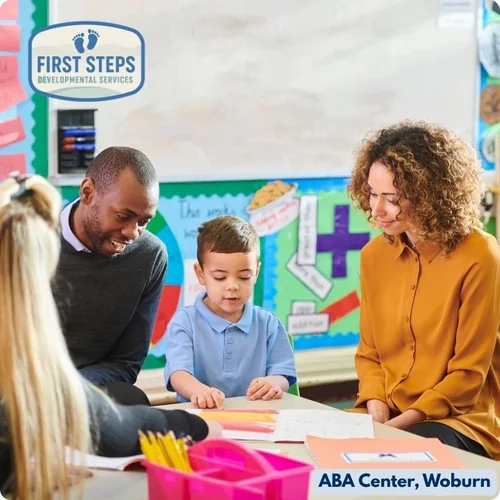 Caregivers and child engaged in hands-on learning activity at First Steps Developmental Services, illustrating personalized coaching and support in a collaborative environment.